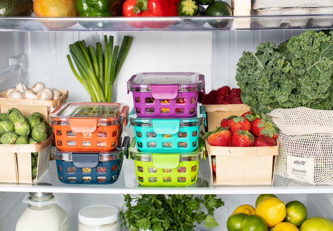 Meal prep containers organized with fresh vegetables and grains